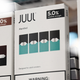 A row of Juul vapes with menthol and tobacco flavors.